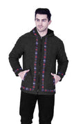A man stands against a white background wearing the aruna kullu handloom Woolen Winter Wear ZIPPER HOODIE Jacket for MEN in grey, featuring colorful patterned trim along the zipper, cuffs, and hem with his hands in the pockets.