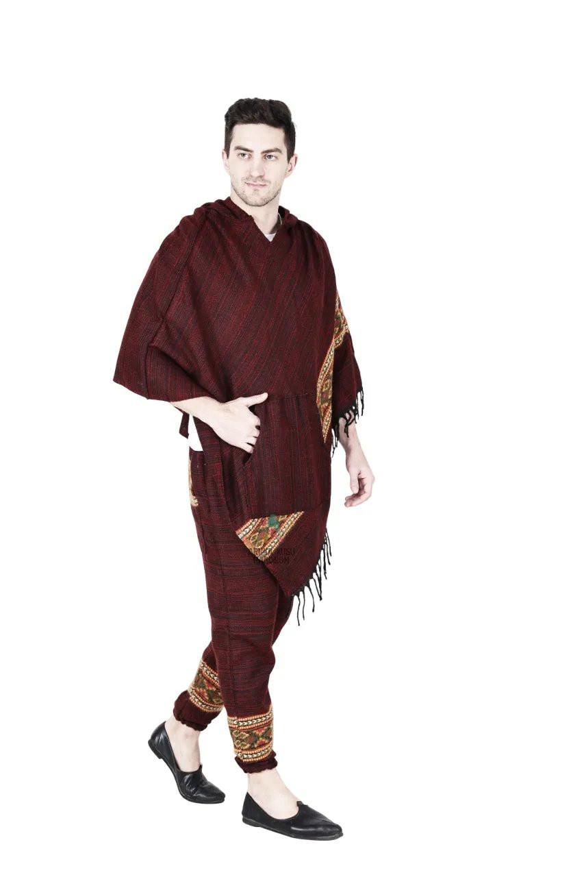A person models the aruna kullu handloom Combo poncho and pajama maroon set with handwoven colorful embroidery, walking forward and looking to the side against a white background.