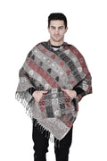 A man stands facing forward with his hands in the front pocket, wearing an Aruna Kullu Handloom grey kullu shawl woolen poncho with hood, featuring red, black, and gray designs, against a plain white background.