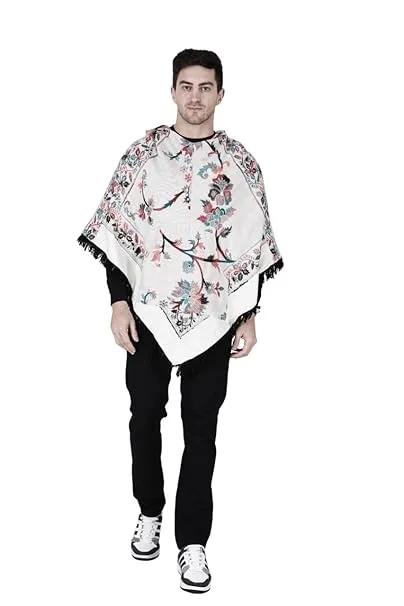 A man with short dark hair models the aruna kullu handloom Shimla jacket price kullu shawl woolen poncho with hood kashmiri silver over a black outfit, standing against a white background.Pahadi poncho for men pahadi kullu poncho mens kullu woolen poncho himachali poncho for men Himachali poncho online