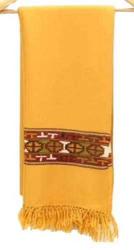 The aruna kullu handloom Kullu Kinnauri Handcrafted Shawl is a mustard yellow woolen shawl with fringed ends and a horizontal band of red, green, white, and yellow geometric patterns near one end, inspired by classic Kinnauri designs.