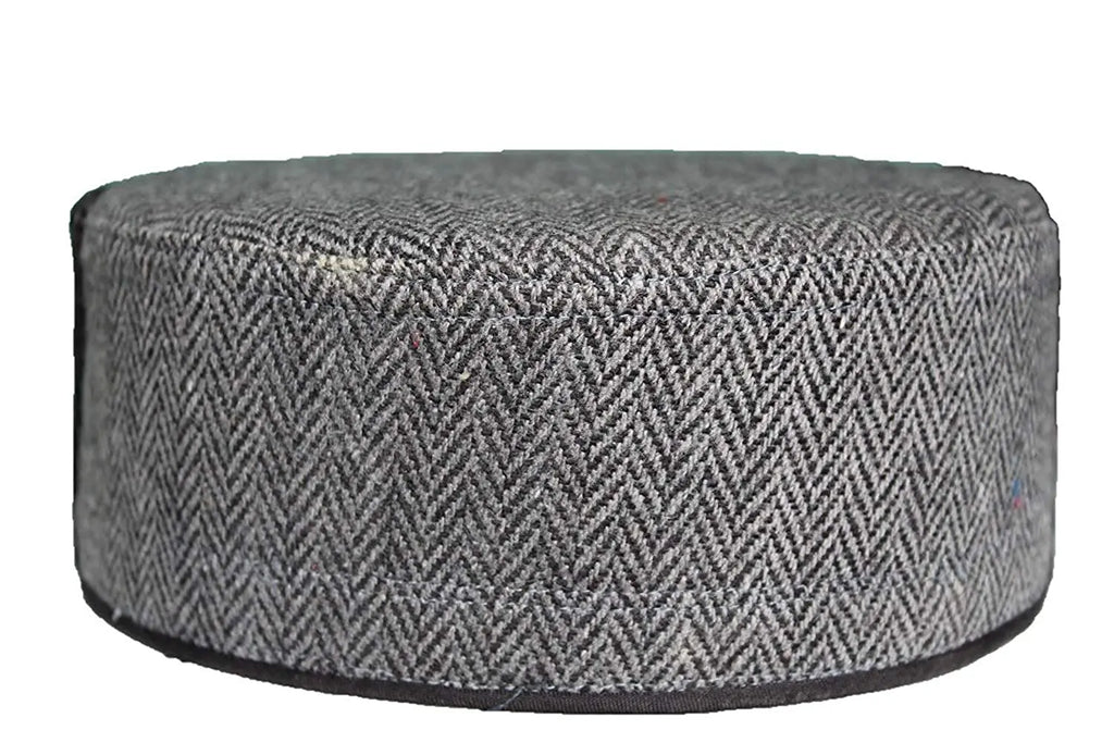 A GREY CENTER BORDER kullu cap by aruna kullu handloom, price 330, features a round, flat shape with a gray body and black-and-white chevron pattern, shown from the side against a white background.