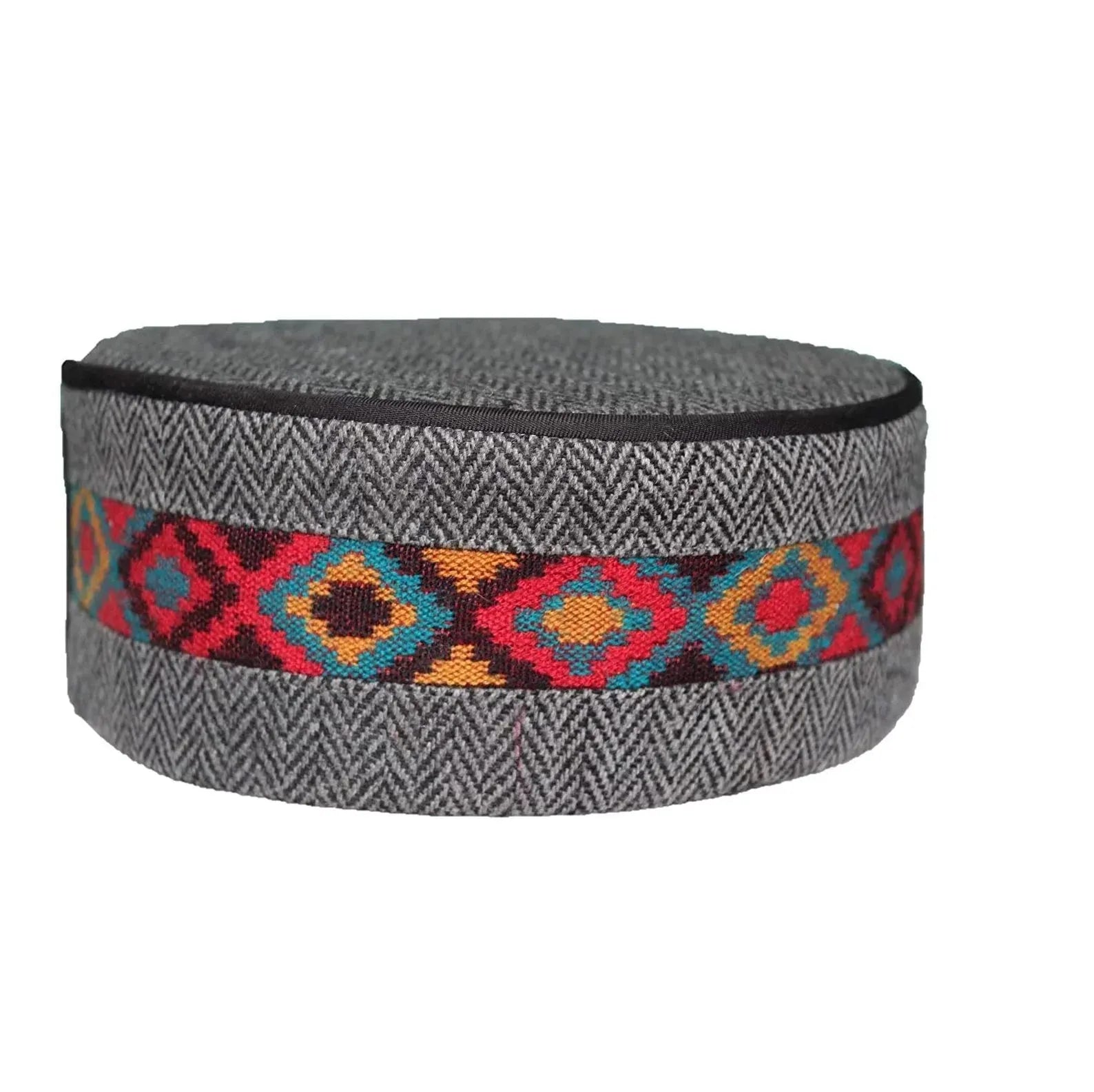 The GREY CENTER BORDER kullu cap by aruna kullu handloom features a round, gray herringbone design with a vibrant geometric band of red, blue, orange, and yellow diamonds. Price: ₹330. Ideal if you’re looking for a unique Kullu cap online.