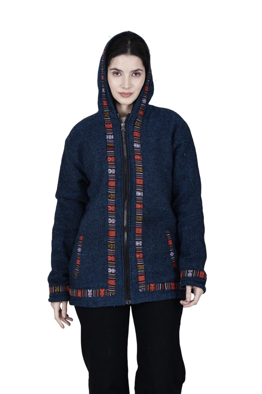 A woman wears an Aruna Kullu Handloom Manali Hoodies woolen hoodie jacket for men & women in Spanish blue with colorful Kullu Patti work trim, standing against a plain white background.