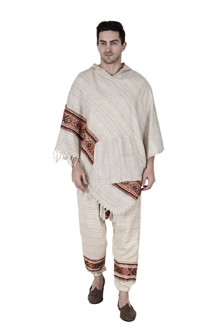 A man wears the "Combo pajama and poncho white singal patti" from aruna kullu handloom, featuring brown and red geometric patterns. He pairs them with brown shoes and stands against a white background.